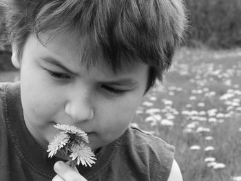 Close-up of boy holding flower