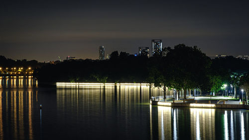 Scenic view of lake against sky at night