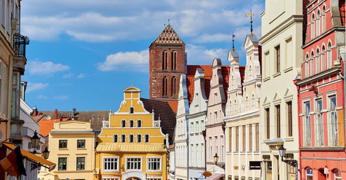 Buildings in town against sky