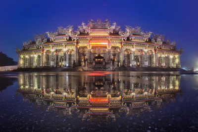 Illuminated building in city at night