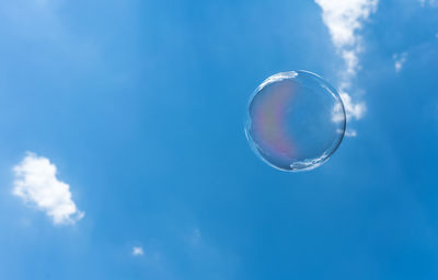 Low angle view of bubbles against sky