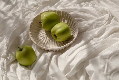 High angle view of apples on bed