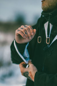 Close-up of tattoos on hands