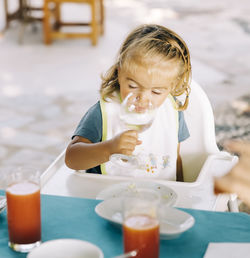 Close-up of girl drinking water in restaurant