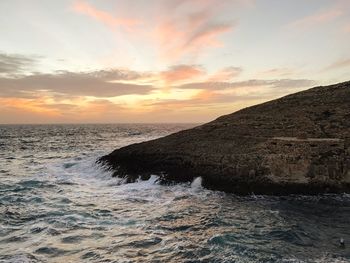 Scenic view of sea against sky at sunset