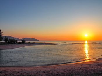 Scenic view of sea against clear sky during sunset