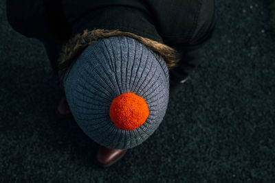 Low section of person holding orange fruit