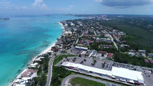 High angle view of buildings by sea against sky