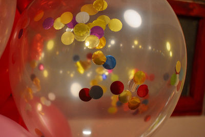 Close-up of multi colored glass on table