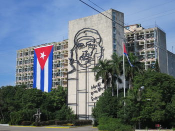 Low angle view of flag against buildings in city