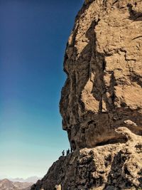 Low angle view of rock formation against clear sky