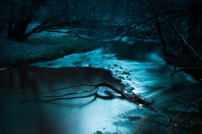 Scenic view of river amidst trees during winter