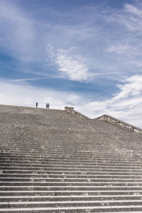 People on staircases against sky