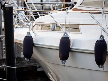 Close-up of sailboats moored at harbor