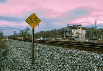 Road sign against cloudy sky