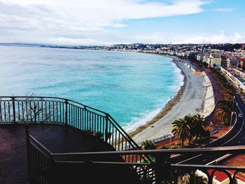 High angle view of steps by sea against sky