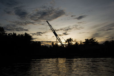 Reflection of windmill in water at sunset