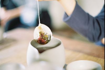 Close-up of hand holding food on table