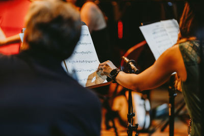 Rear view of people playing piano