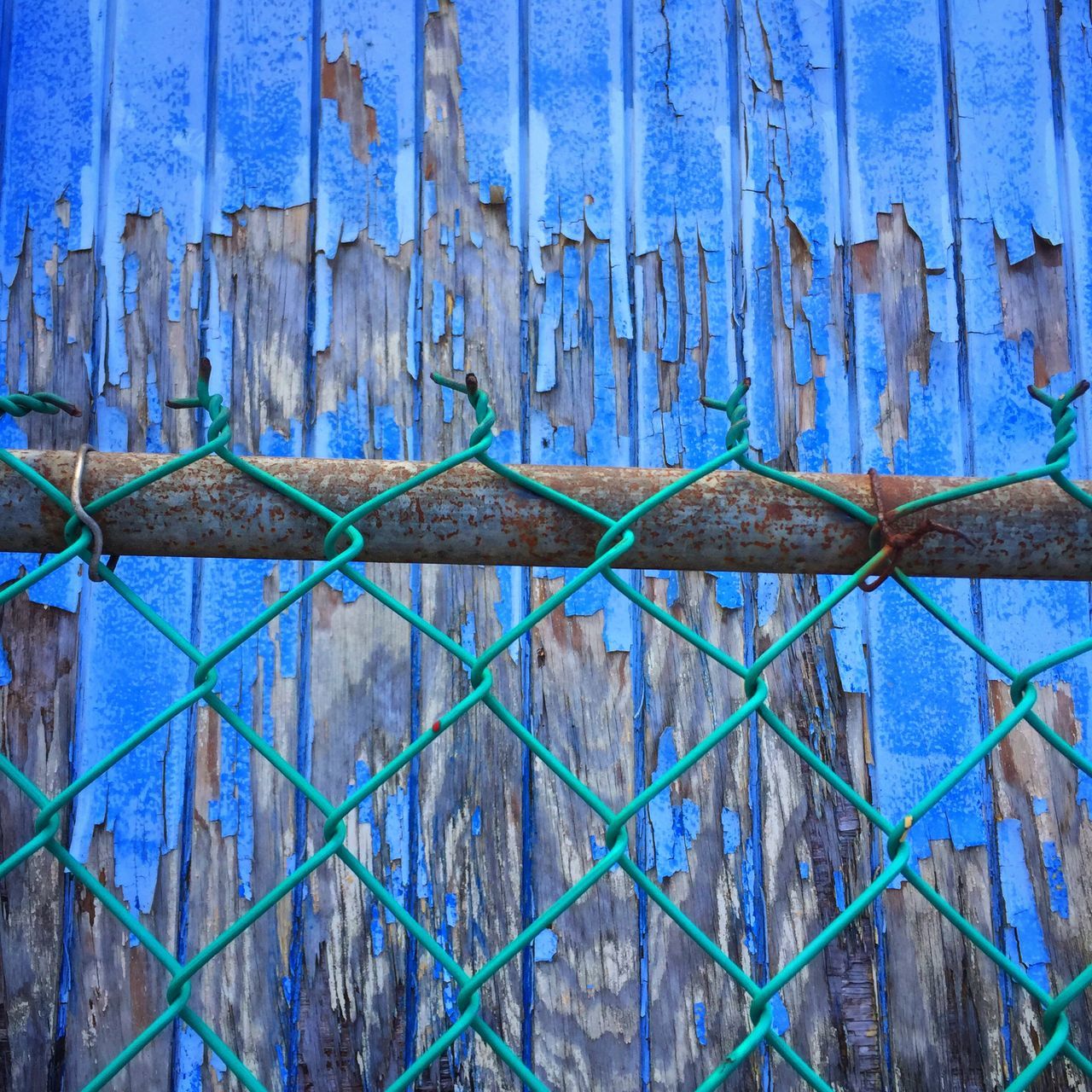 full frame, backgrounds, blue, metal, protection, built structure, pattern, safety, architecture, textured, wall - building feature, close-up, security, weathered, fence, closed, rusty, building exterior, metallic, old