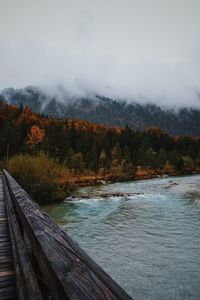 Scenic view of lake by trees against sky