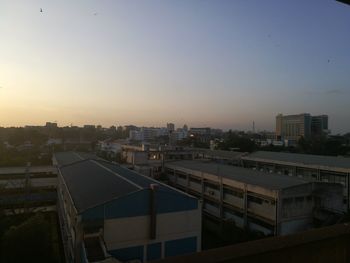 Cityscape against clear sky during sunset