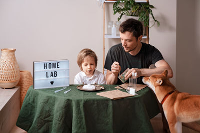 Father and son experimenting in the home laboratory and studying the chemical properties