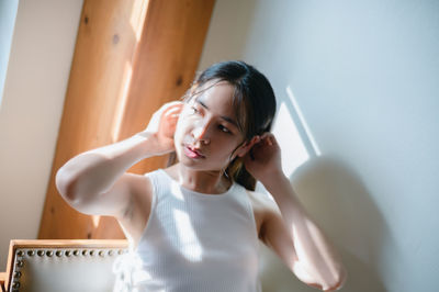 Portrait of young woman sitting at home