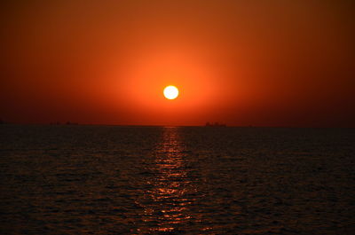 Scenic view of sea against orange sky