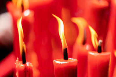 Close-up of lit candles in temple