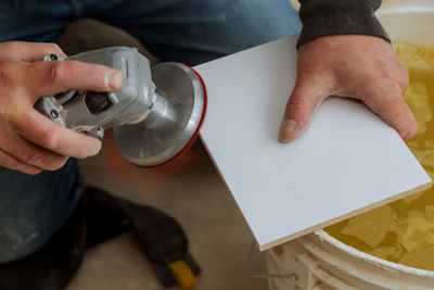 Midsection of man working on table