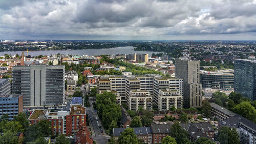 Cityscape against cloudy sky