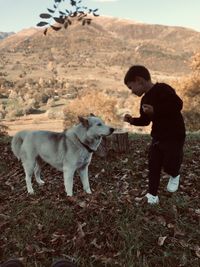 Full length of man with dog on land