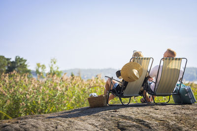 Couple relaxing on sun loungers