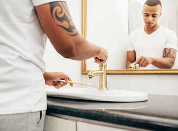 Midsection of man working on table