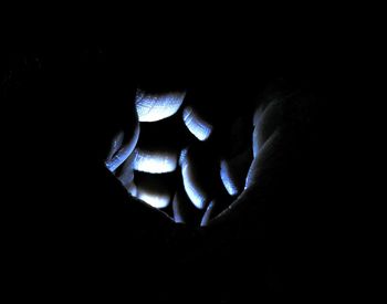 Close-up of human hand in darkroom