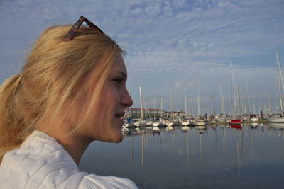 Close-up of woman at harbor against sky