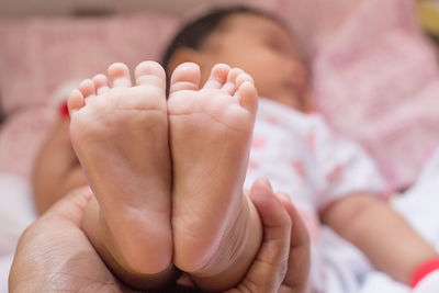 Close-up of hand holding baby feet