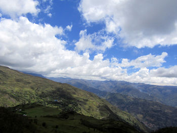 Scenic view of valley and mountains against sky