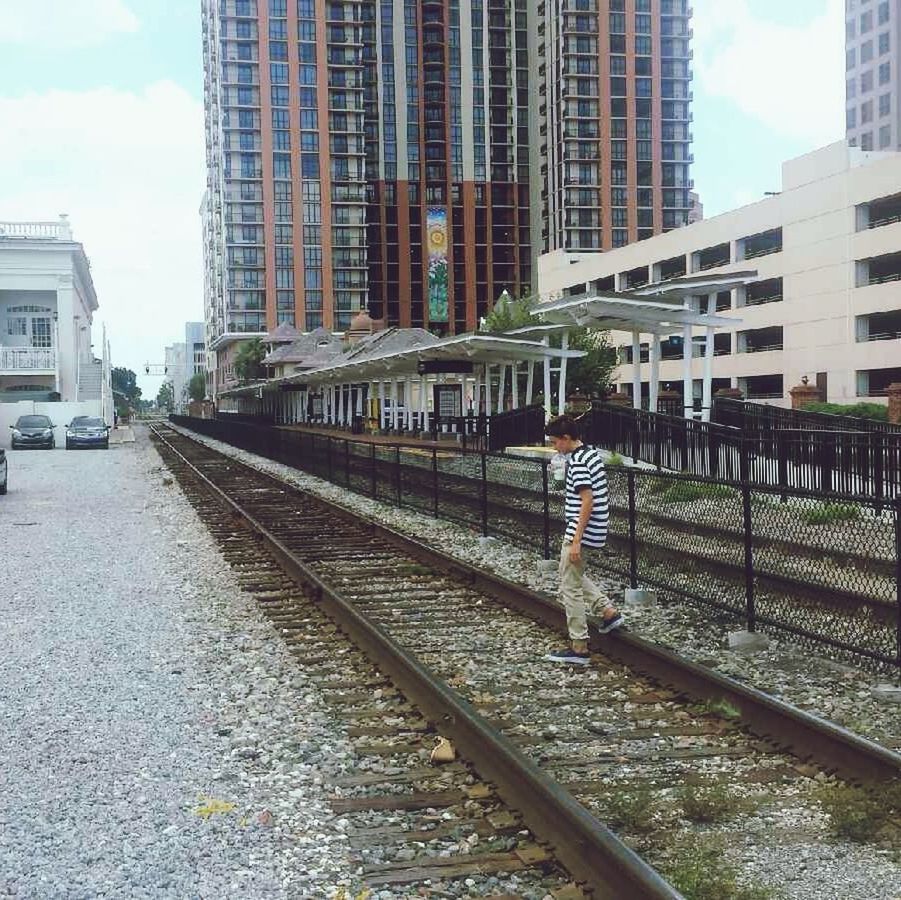 building exterior, architecture, built structure, city, sky, building, transportation, office building, modern, skyscraper, railroad track, city life, incidental people, day, reflection, outdoors, tower, railing, street, cloud - sky