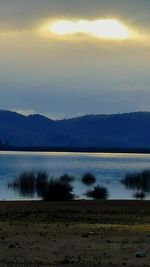 Scenic view of lake at sunset