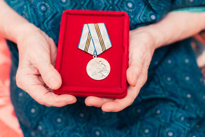 Close-up of woman holding red hand