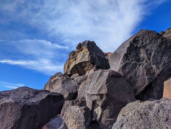 Low angle view of rock formation against sky