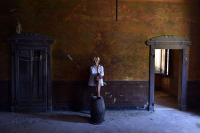 Woman standing by door of building