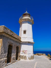 Low angle view of lighthouse against clear blue sky