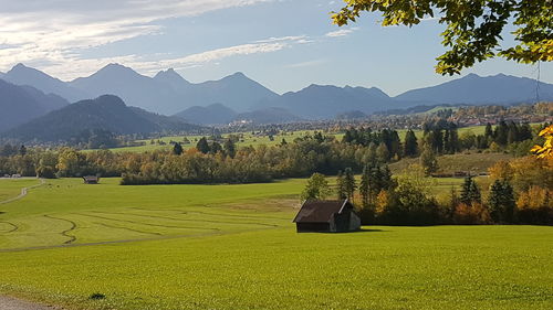 Scenic view of field and mountains against sky