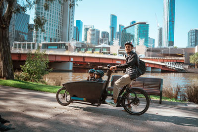 Side view of woman using mobile phone in city