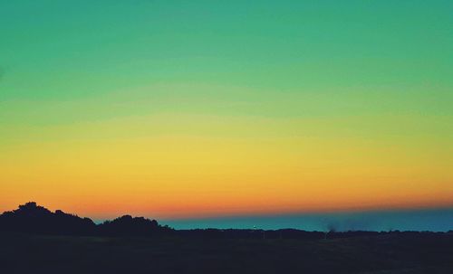 Scenic view of silhouette landscape against sky during sunset