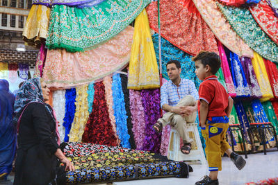 People standing in multi colored market