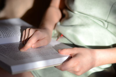 Midsection of woman using laptop